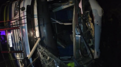 Overturned bus by night