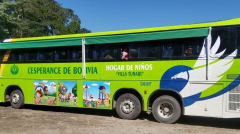 New school bus painted green and with pictures