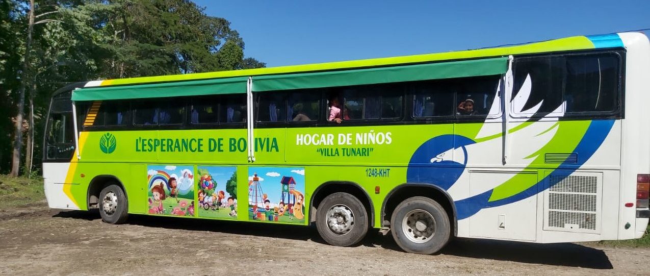 New school bus painted green and with pictures