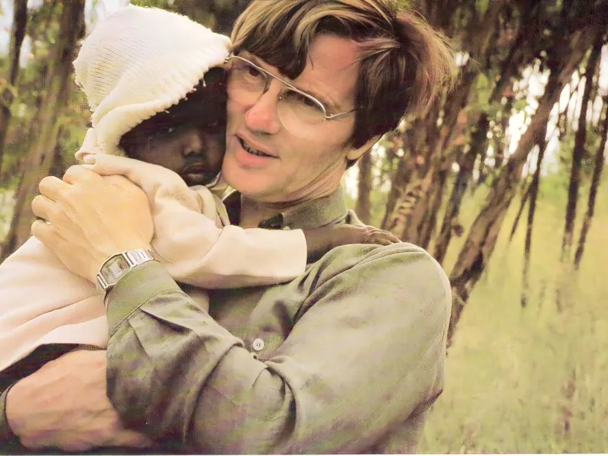 Paul Kowoll with baby in Akaki, 1988